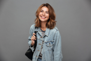 girl with jean jacket smiling