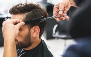 barber using scissors and comb