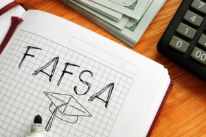 Fafsa And Graduation Cap Are Drawn In Notebook Next To Calculator