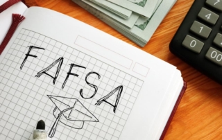 Fafsa And Graduation Cap Are Drawn In Notebook Next To Calculator