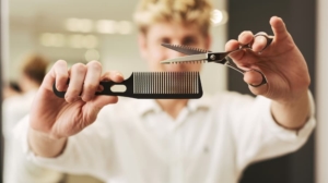 Hairdresser holding scissors and a comb