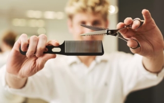 Hairdresser holding scissors and a comb