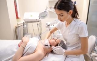 Female esthetician performing professional skin treatment to a female client