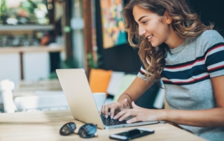 Student researching beauty school financial aid on laptop